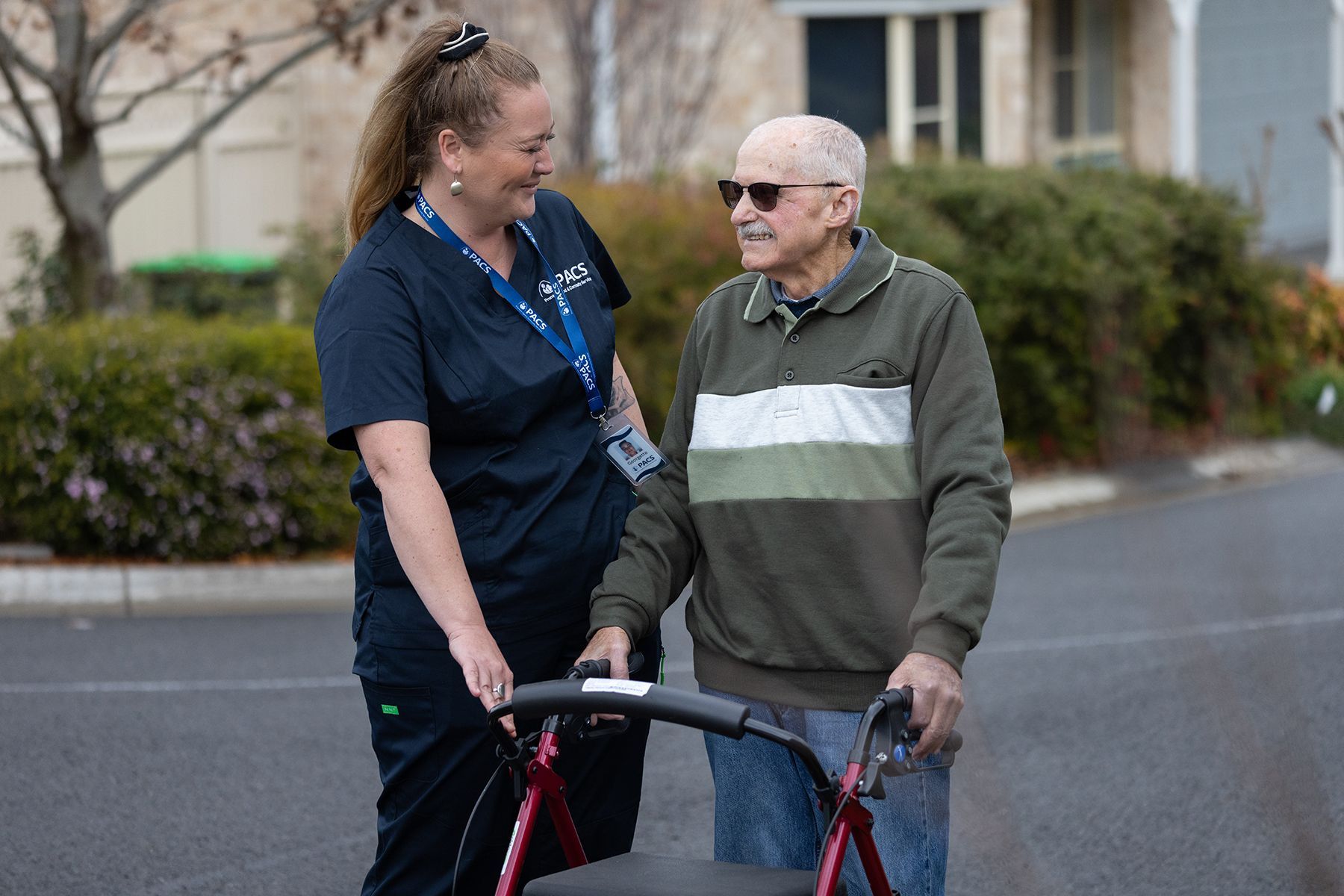 Caregiver Assists a Person Using a Walker — Premium Aged & Community Services In Tamworth, NSW