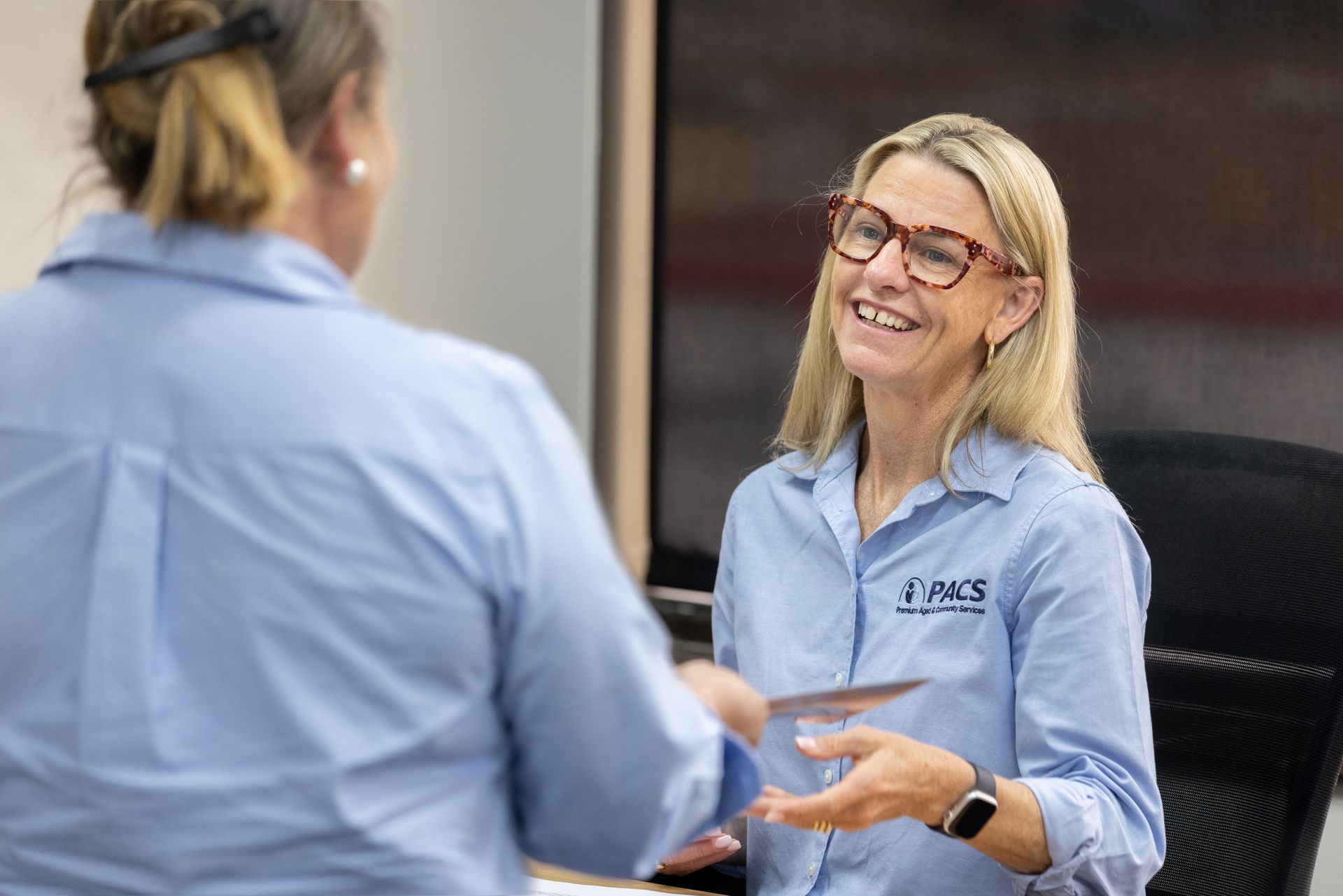 Woman in Glasses Smiles, Talking to Another Woman — Premium Aged & Community Services In Tamworth, NSW