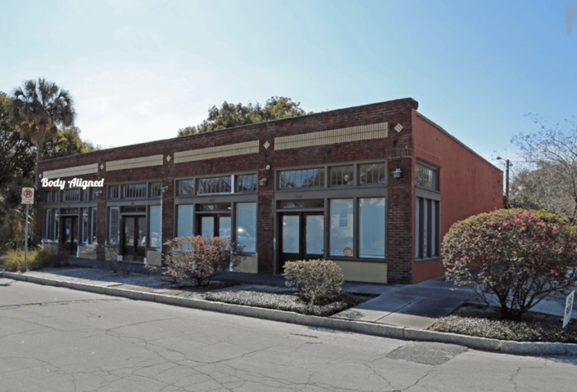 A brick building with a lot of windows and a sign that says lucky strike