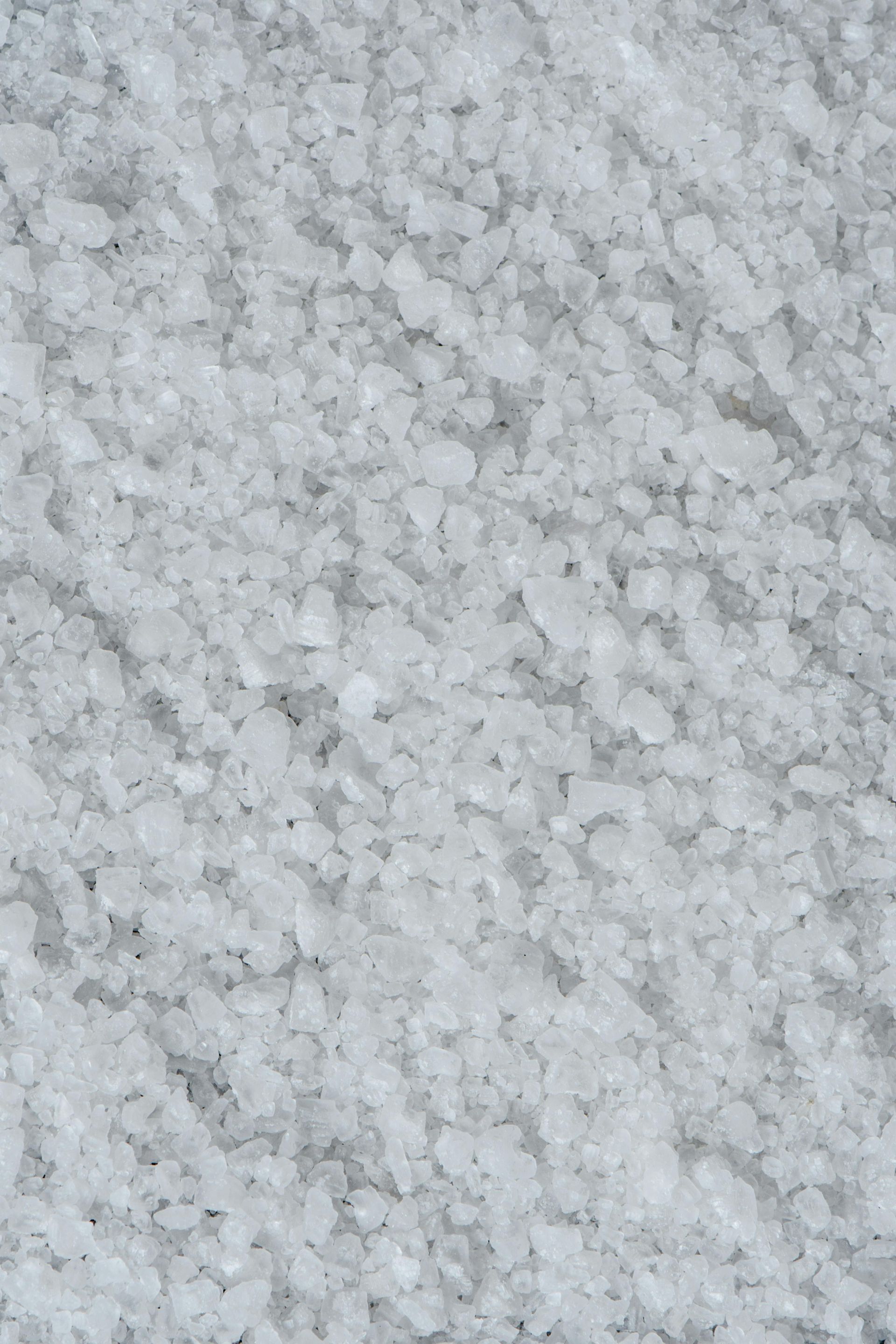 Close-up of white salt crystals, textured and scattered.