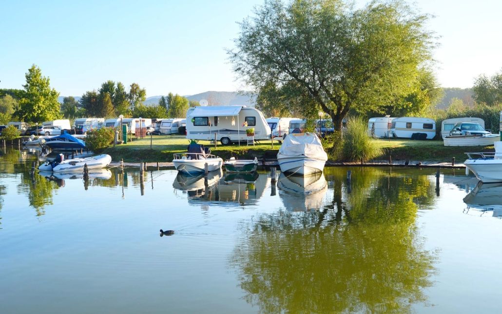 Campsite with boats and rvs A lake with a lot of boats in it