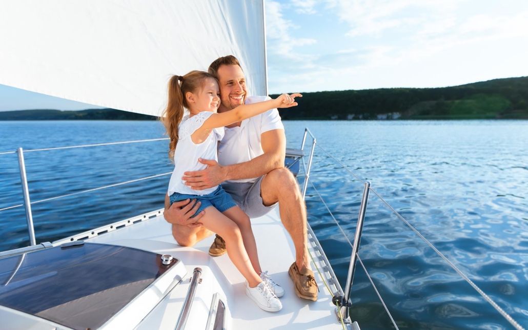 Father sitting with daughter on boat. Father sitting with daughter on boat.
