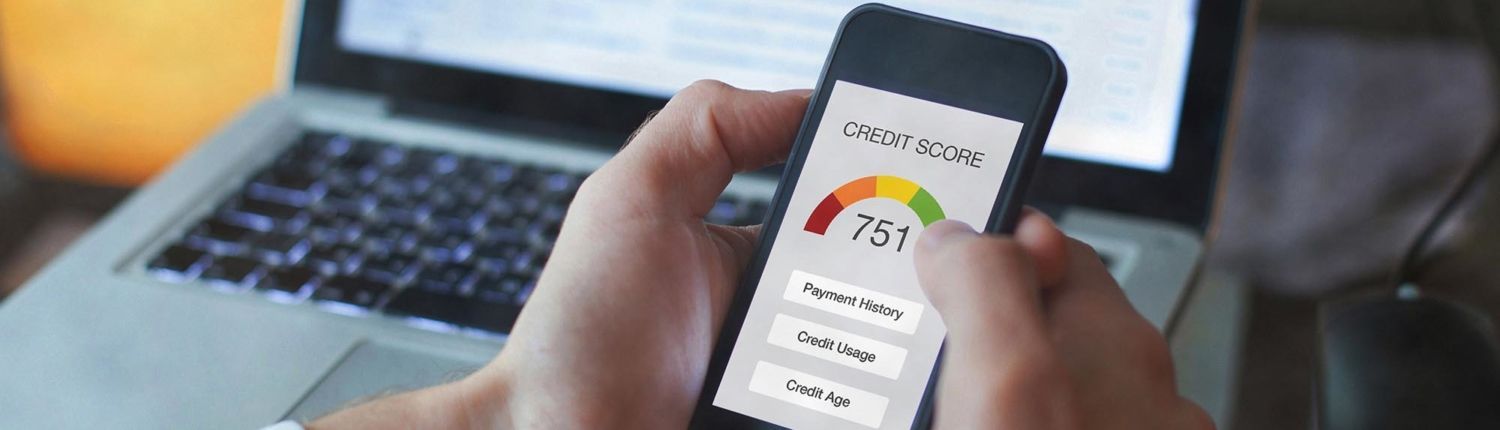 Improving your credit score to qualify for better financing January Blog 2 close up of hands holding phone with credit score