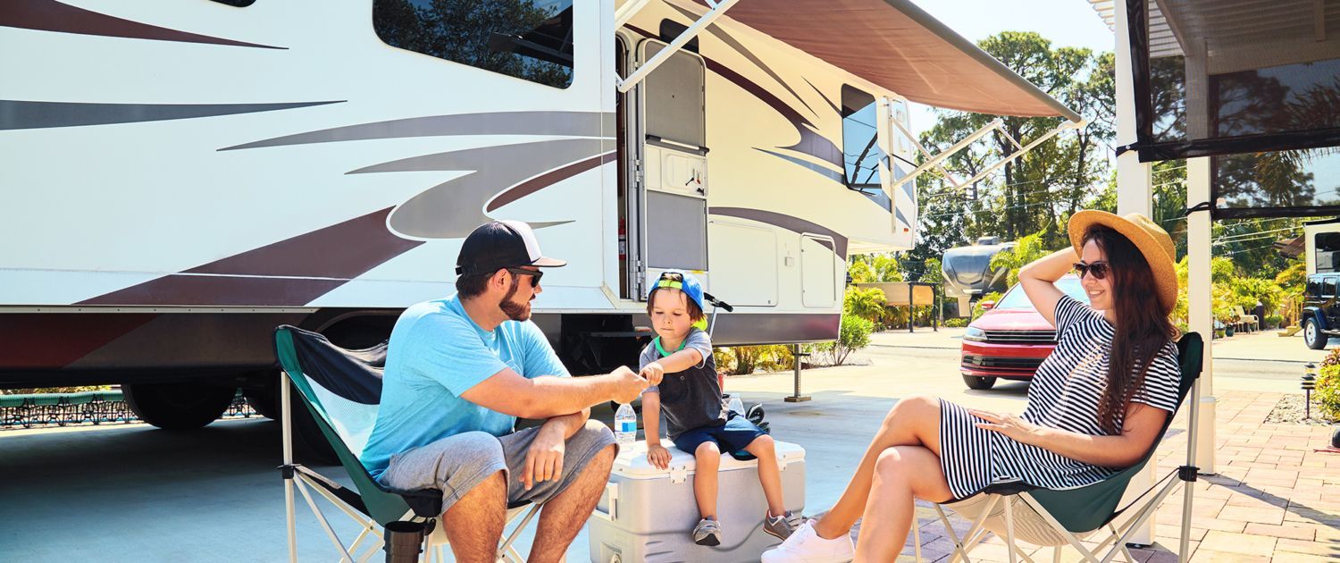 September 2 Mother, Father, and Son sitting in front of RV