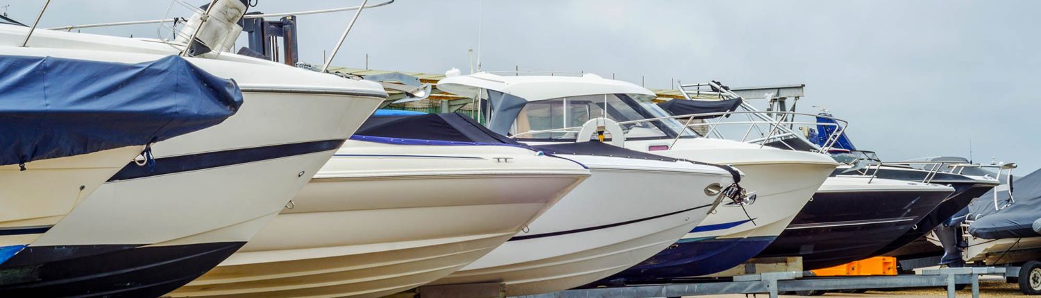 new boat vs used boat financing May Blog 1 A row of boats are parked next to each other in a marina.