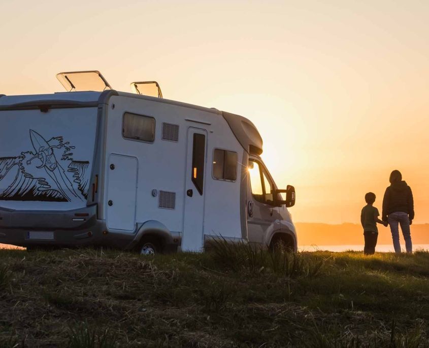 woman with child looking at the sunset by the rv_ woman with child looking at the sunset by the rv_