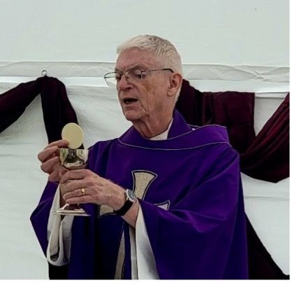 A man in a purple robe is holding a chalice