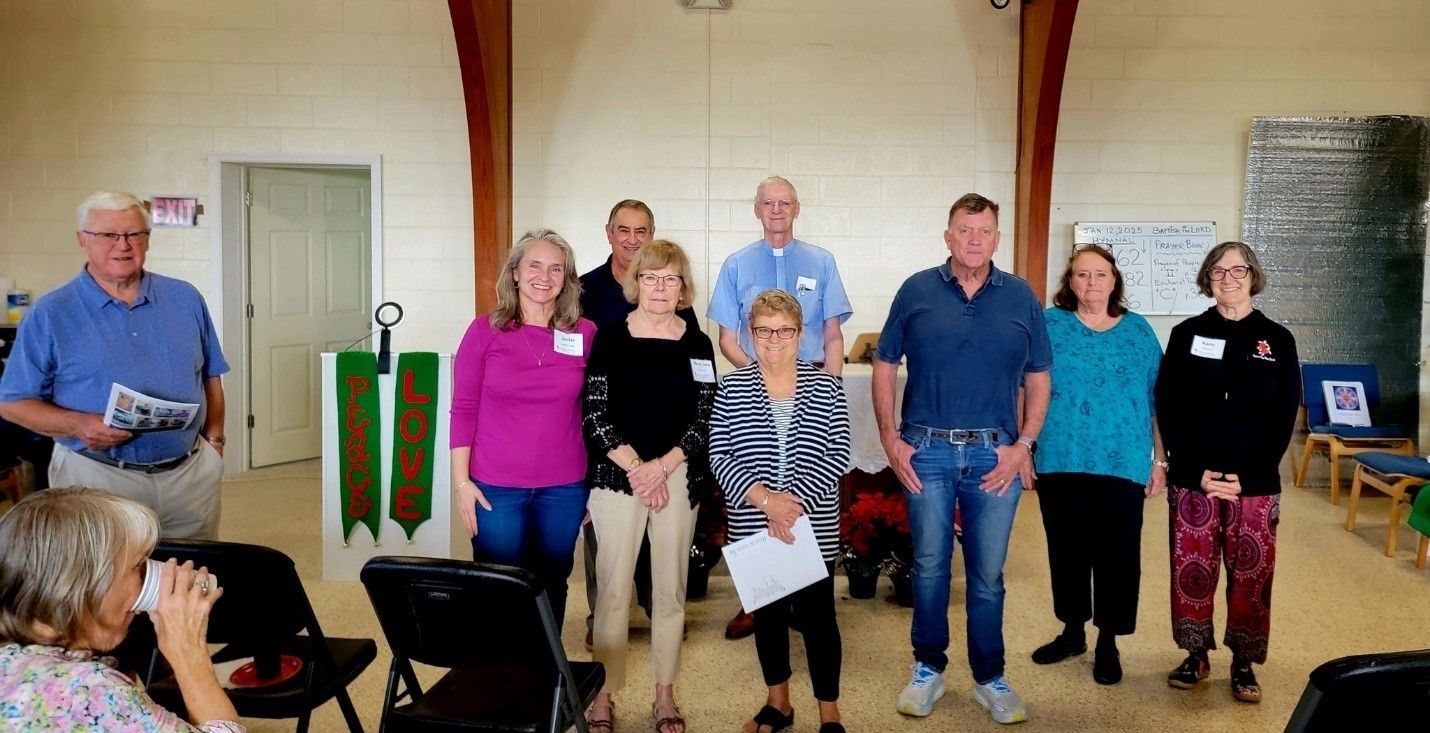 A group of people standing next to each other in a room.