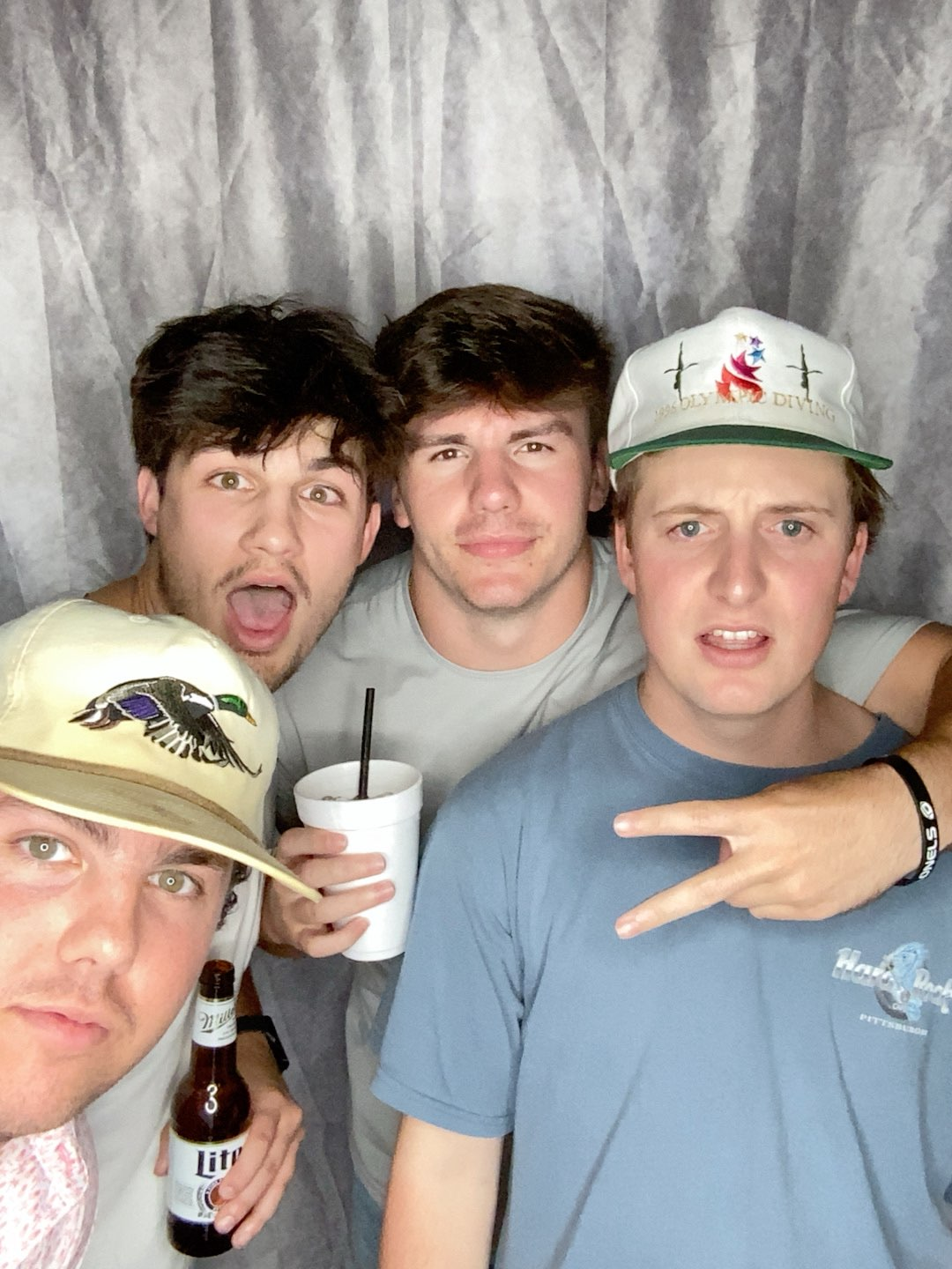 A group of young men are posing for a picture in a photo booth.