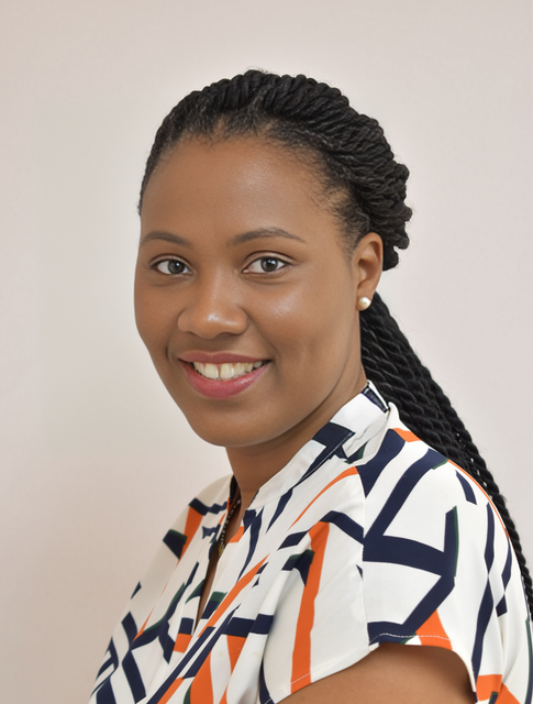A woman wearing a striped shirt is smiling for the camera