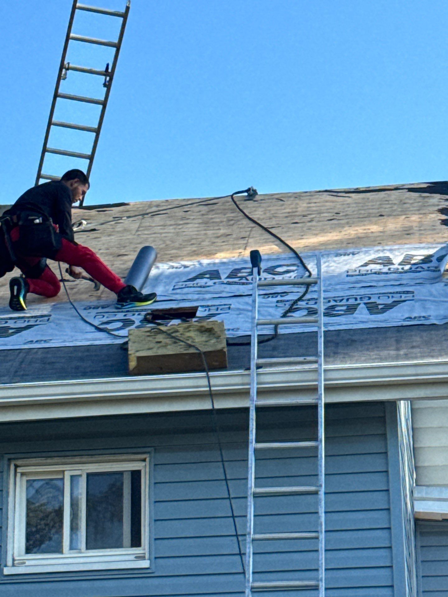 Diamond Roofing Pros working on metal roof