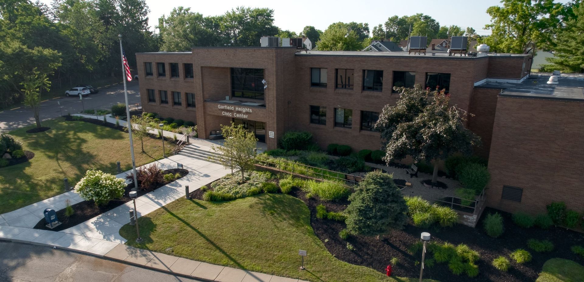Aerial view of a brick campus building in Garfield Heights, Ohio with a landscaped courtyard, walkways, and trees.