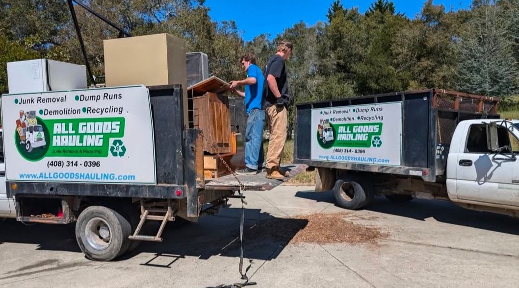 Two people loading furniture into two 