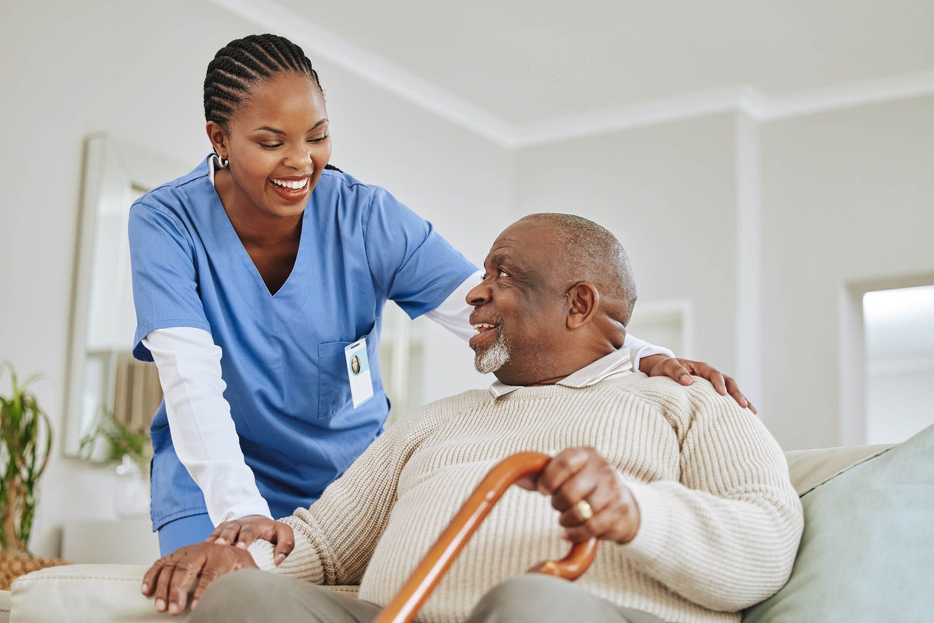 A caregiver is checking on a senior man. A caregiver is checking on a senior man.