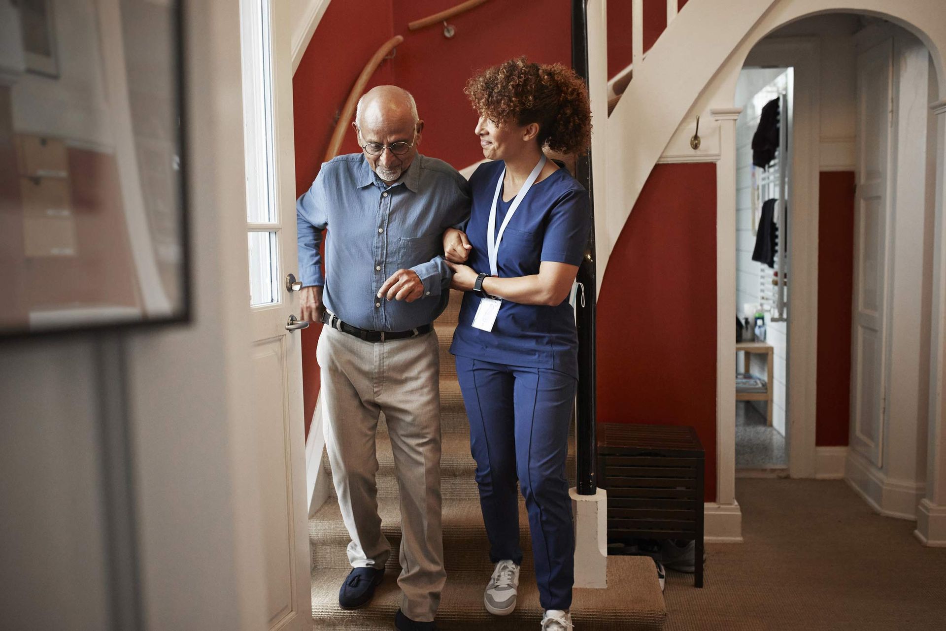 Nurse walking with senior man on steps. Nurse walking with senior man on steps.