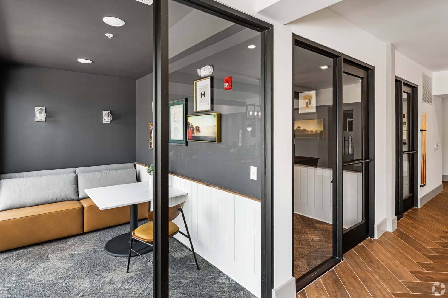 A room with a couch , table and chairs in it.