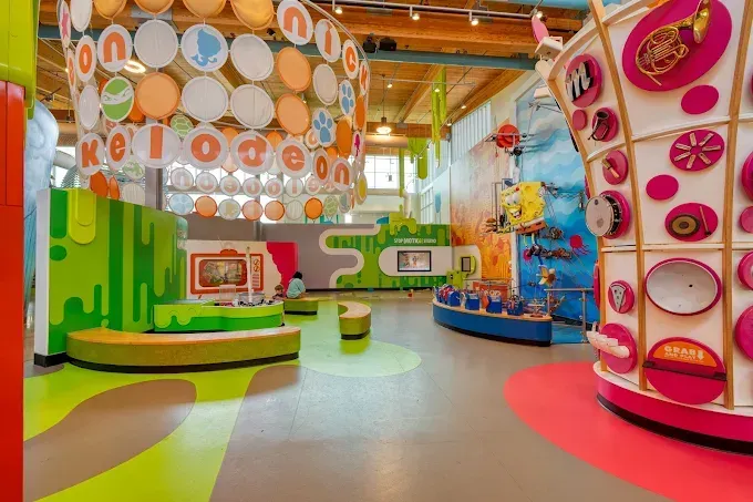 Colorful children's play area with Nickelodeon theme. Includes interactive displays, bright colors, and playful decorations.