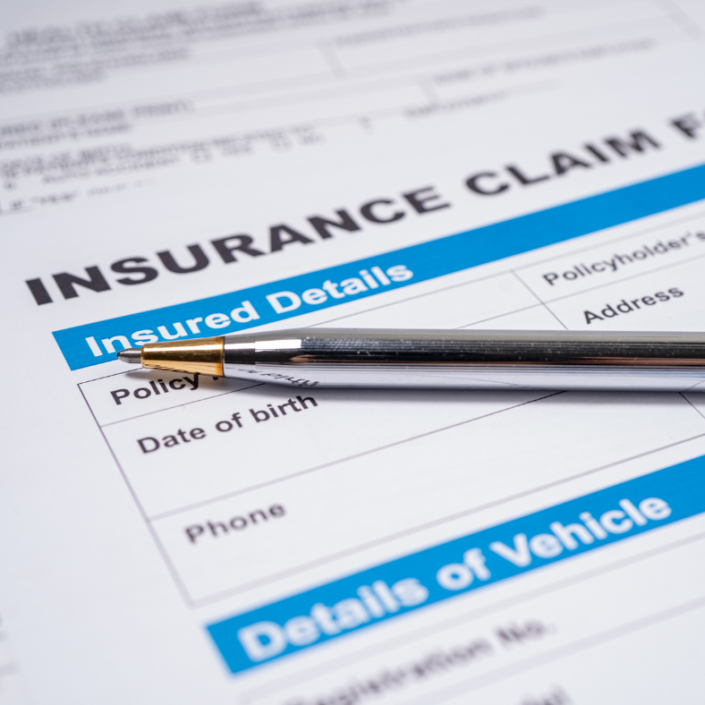 A pen is sitting on top of an insurance claim form.