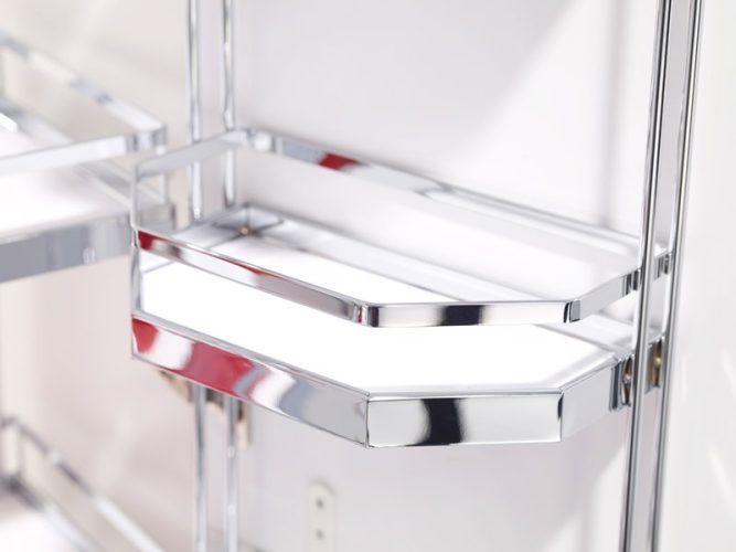 Chrome corner shelving unit against a white wall.