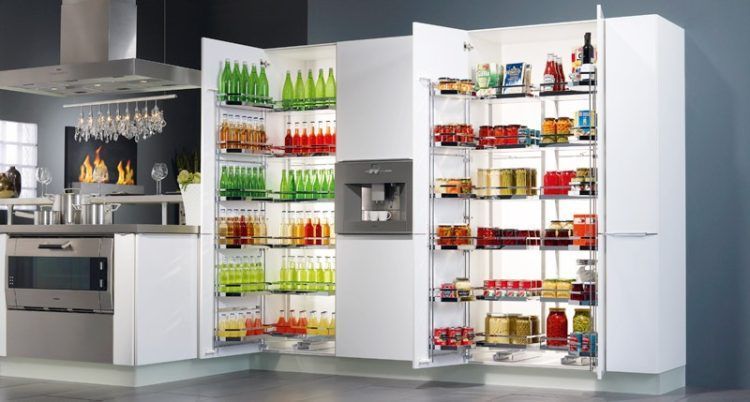 White kitchen pantry with glass shelves, stocked with beverages and food items.