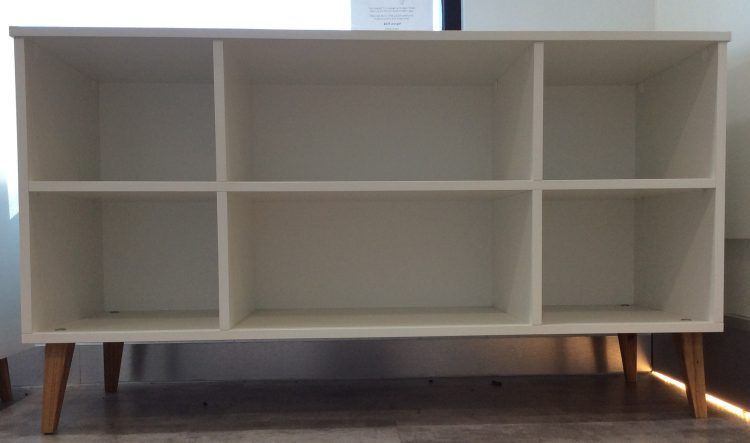 White shelf with six cubbies and wooden legs.