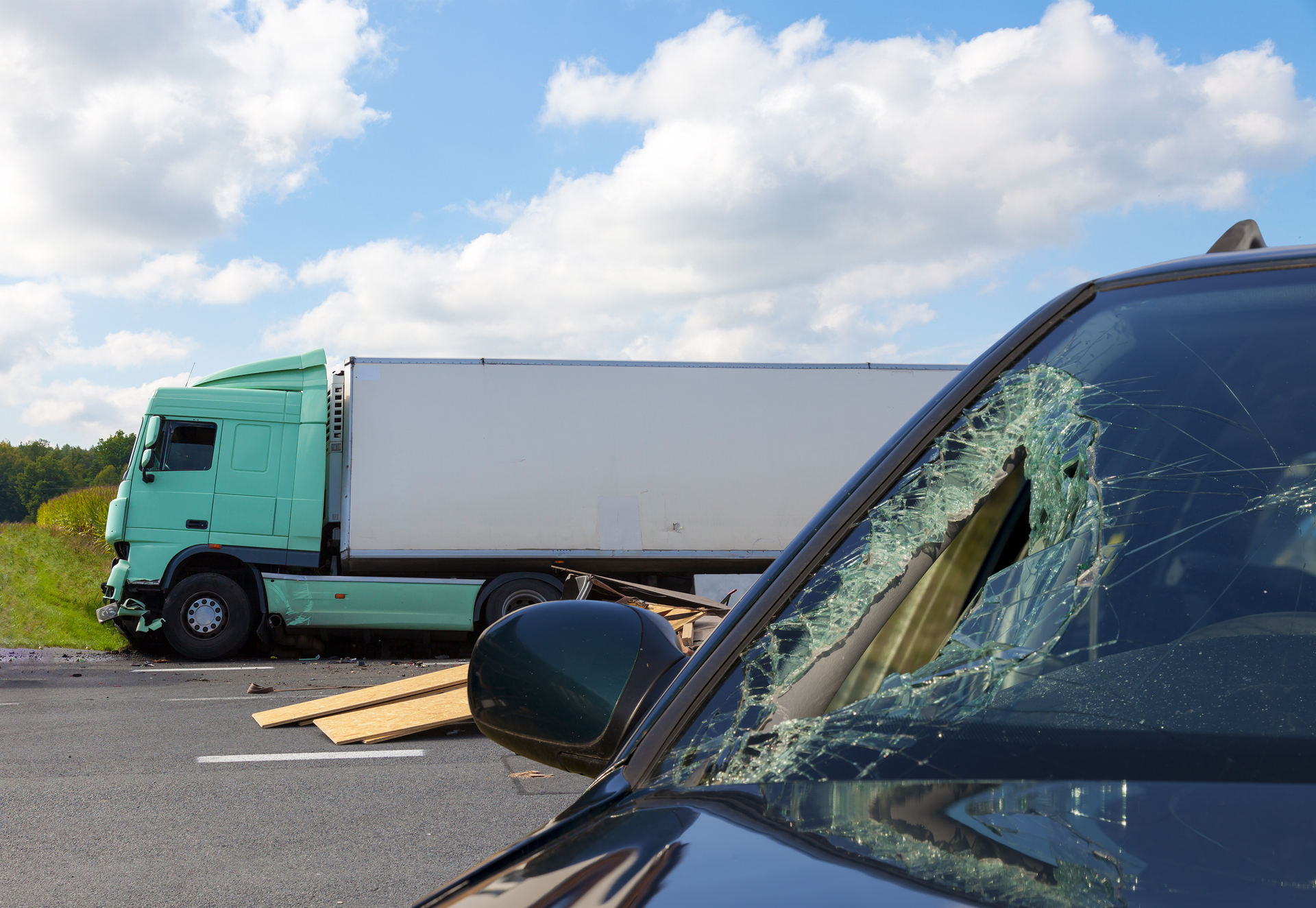 View of a truck in an accident with a car.