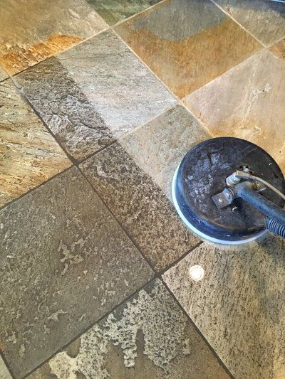 A tile floor is being cleaned with a machine.