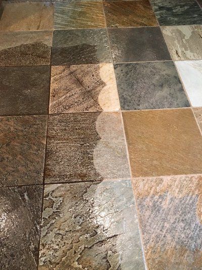 A close up of a tiled floor with a shadow of a person on it.