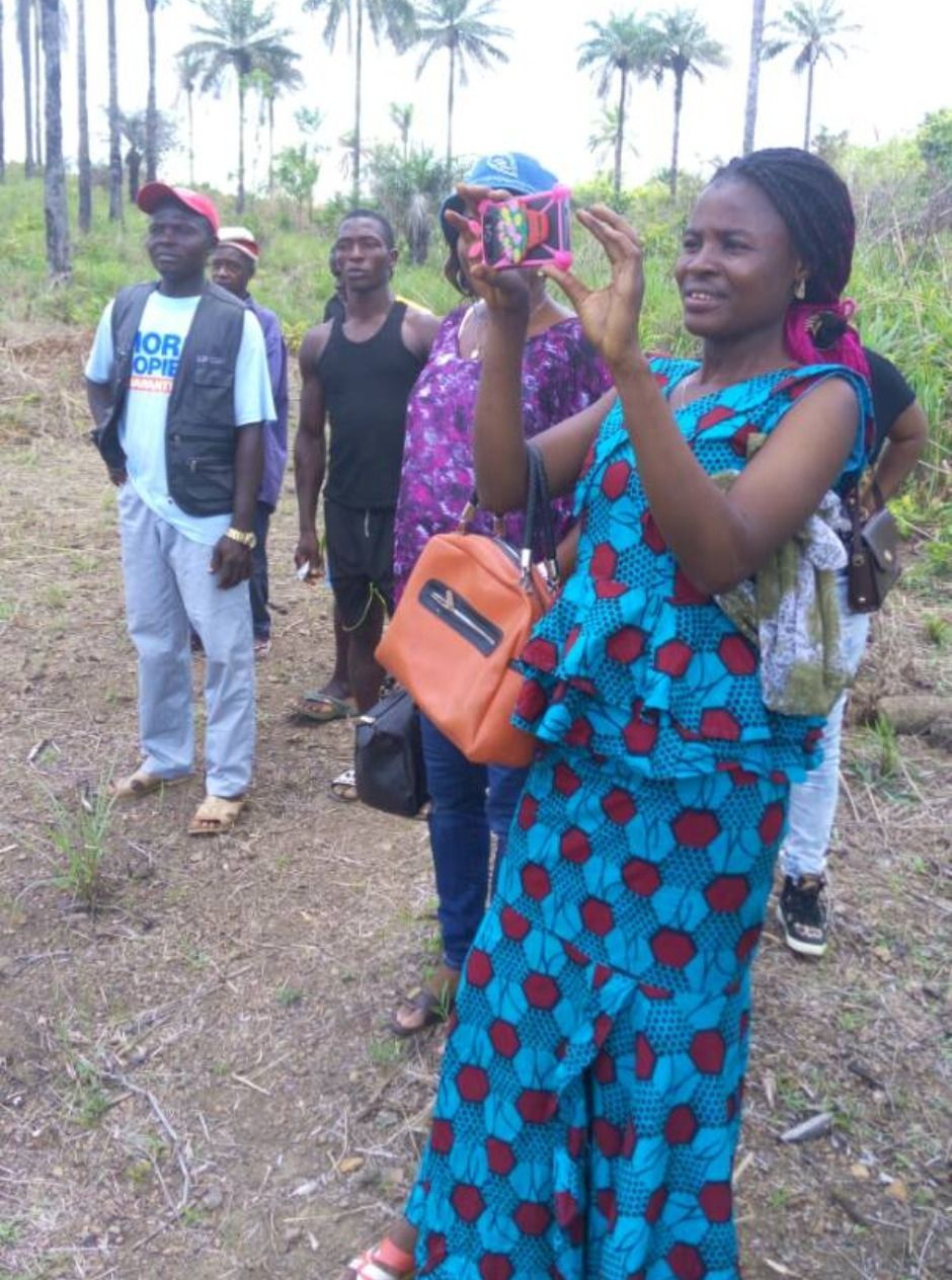 woman taking pictures with other locals