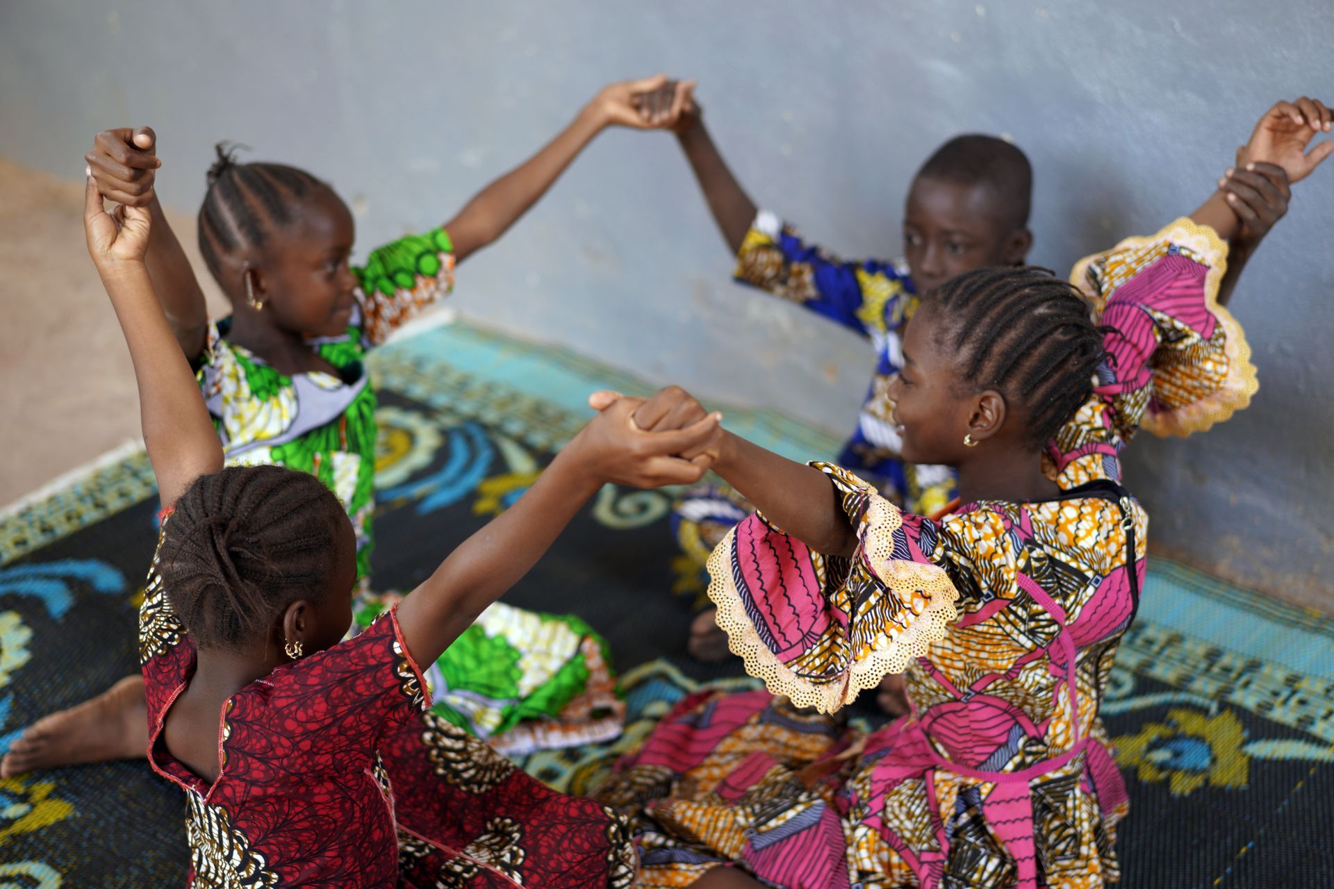 children playing raising their hands
