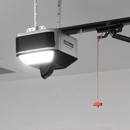 Garage door opener with light and emergency pull cord.