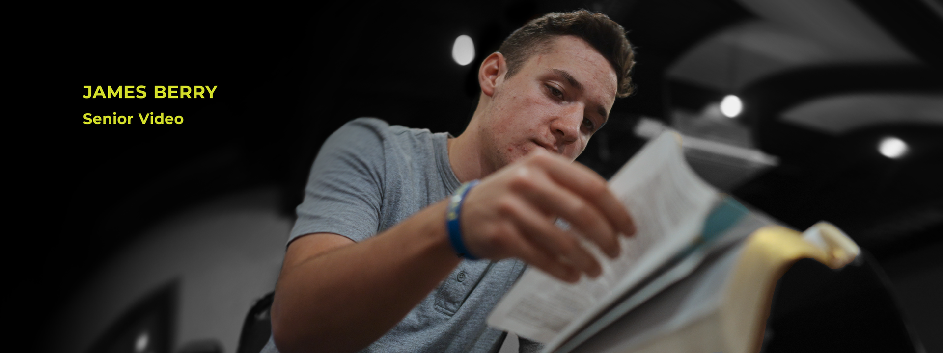 A man is reading a book with the name james berry on the bottom