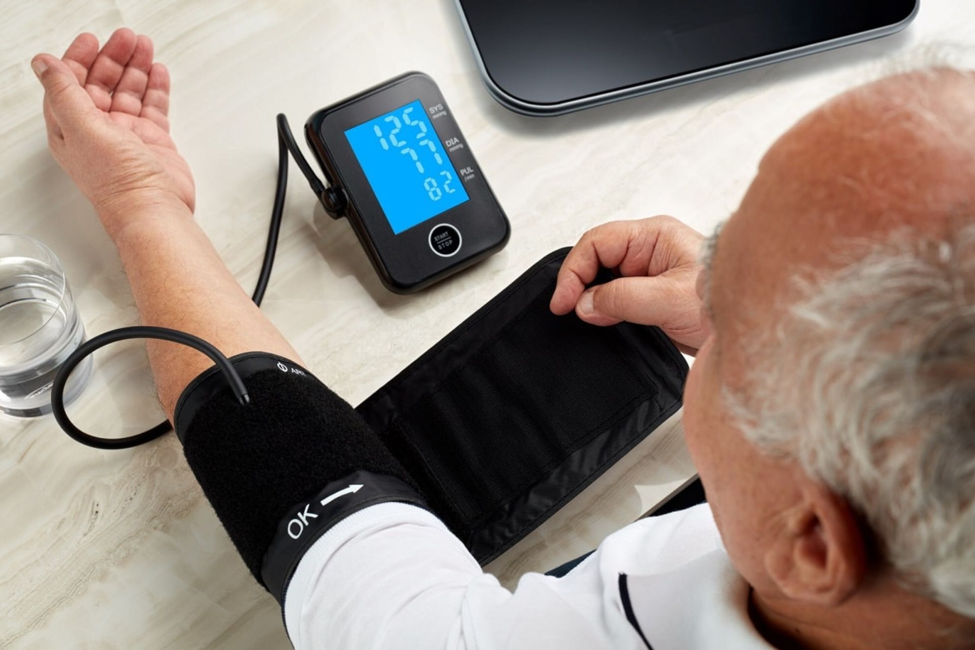 patient taking his blood pressure at home