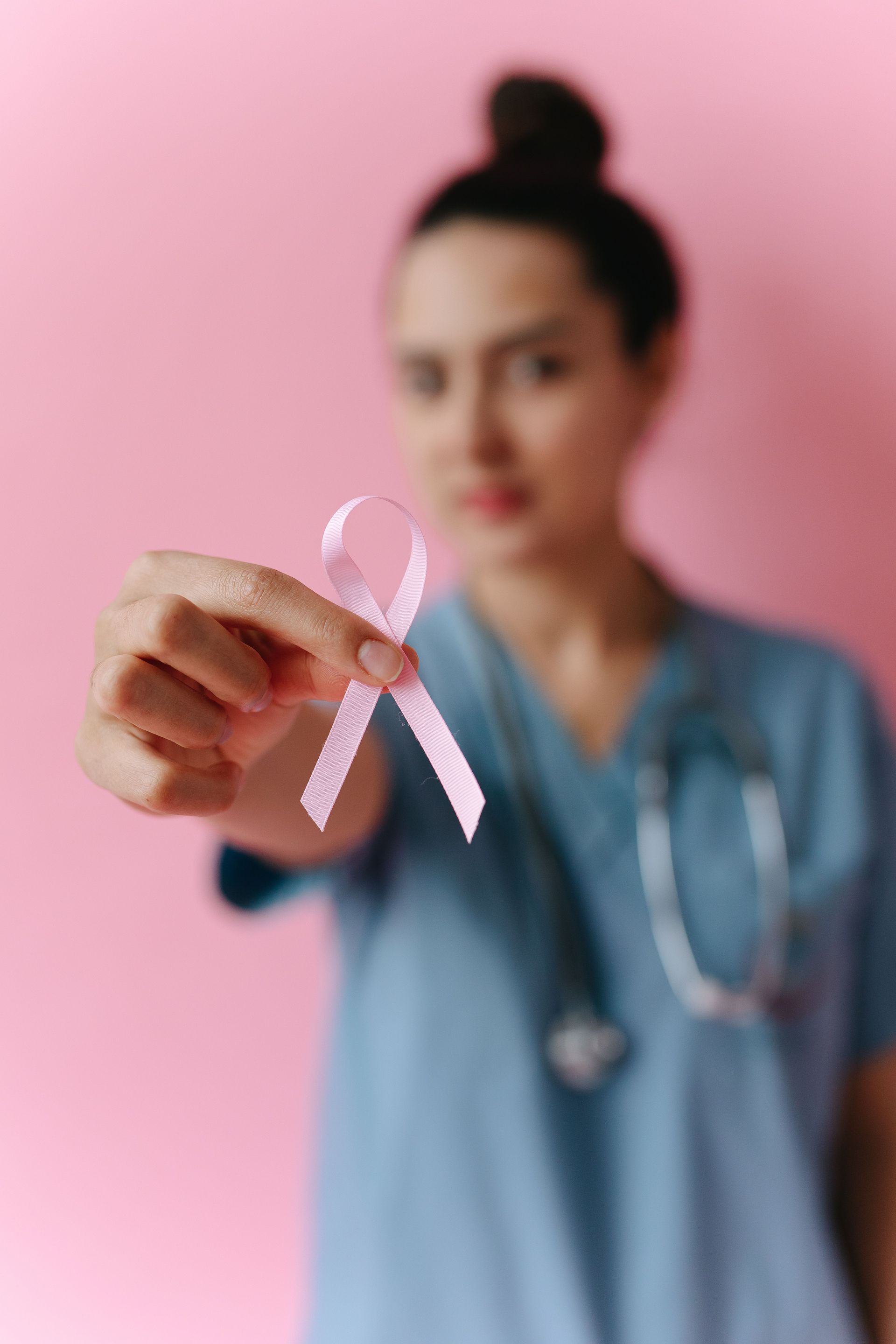 oncologist showing breast cancer ribon
