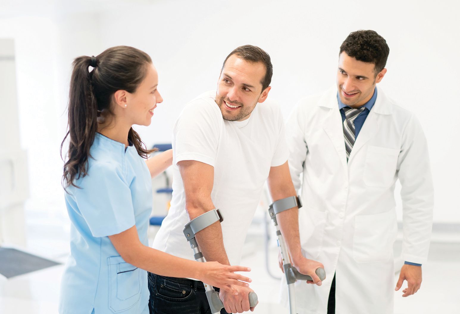 Doctor and nurse helping a patient walk