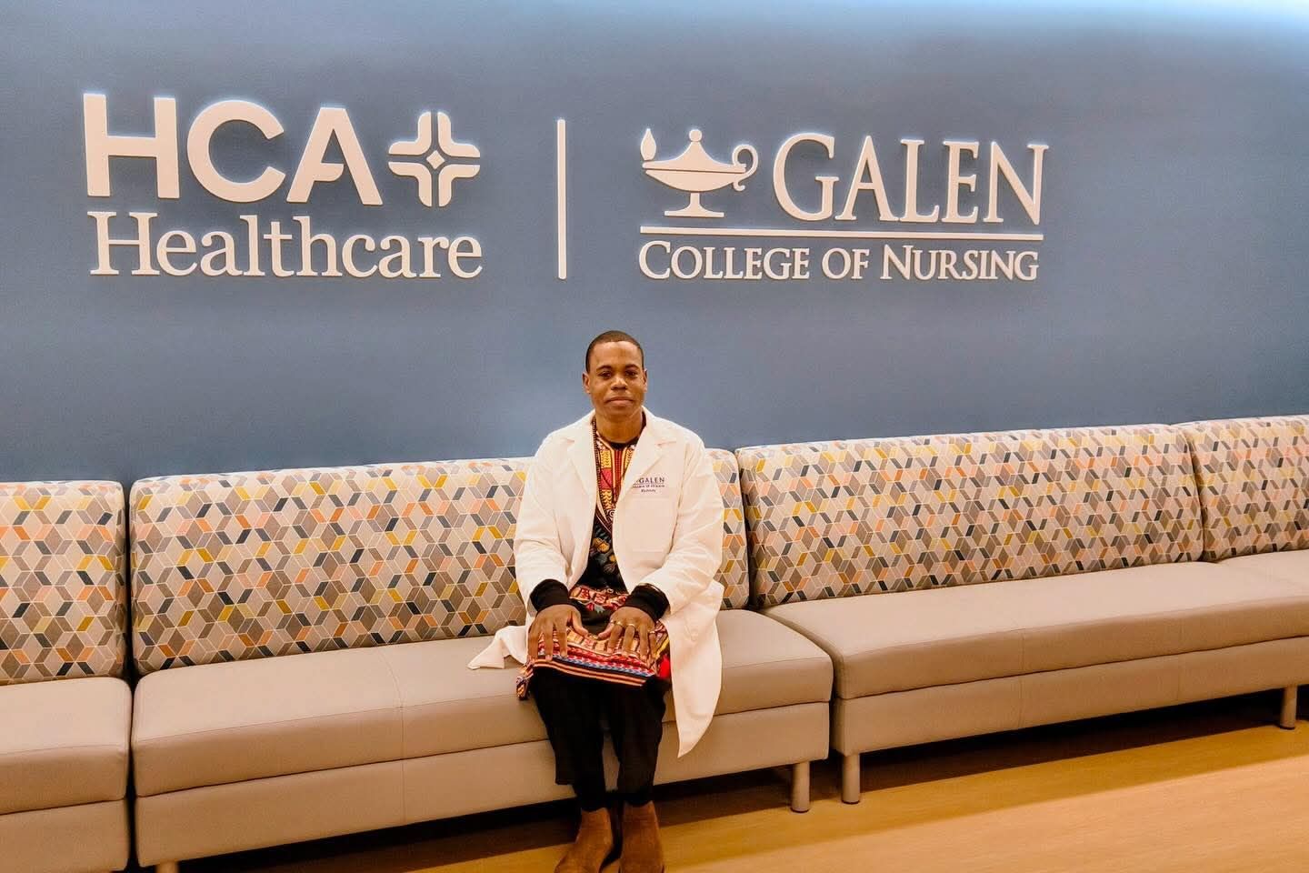 Person seated on a long beige couch in front of HCA Healthcare and Galen College of Nursing logos.