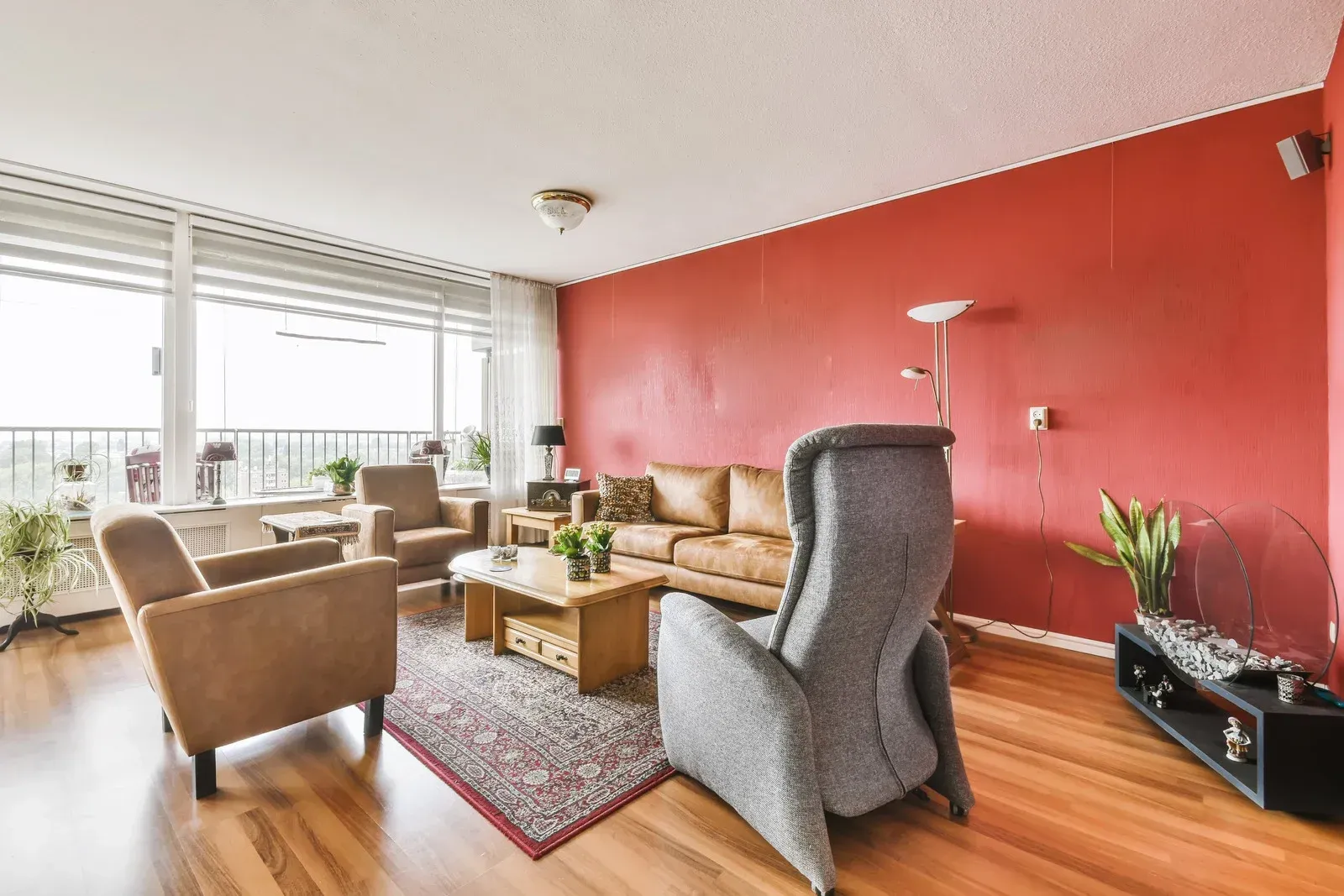 Stone outdoor pavilion with a dark wooden roof, built-in grill, and bench seating.