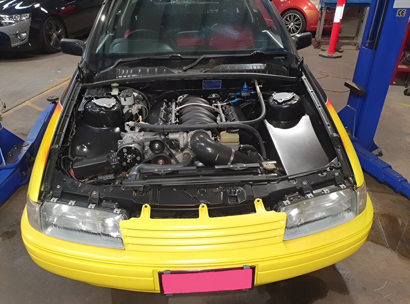 A Yellow Car With a License Plate That Says 00 Lid — Aitkenvale Auto & Dyno in Aitkenvale, QLD