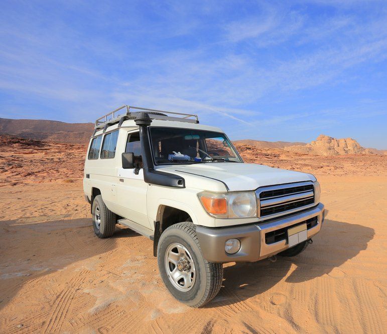 A White Suv is Parked in the Middle of a Desert — Aitkenvale Auto & Dyno in Aitkenvale, QLD