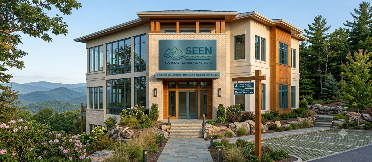 Modern two-story building with glass facade, stone steps, and landscaped gardens in a mountain setting