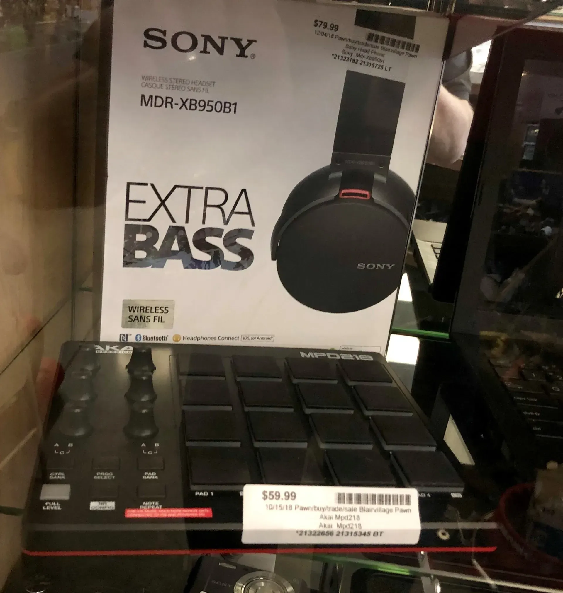 Sony Extra Bass headphones box displayed on a store shelf above a black keyboard.
