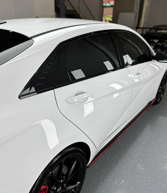 A white car installed ceramic tint on all windows in their home.