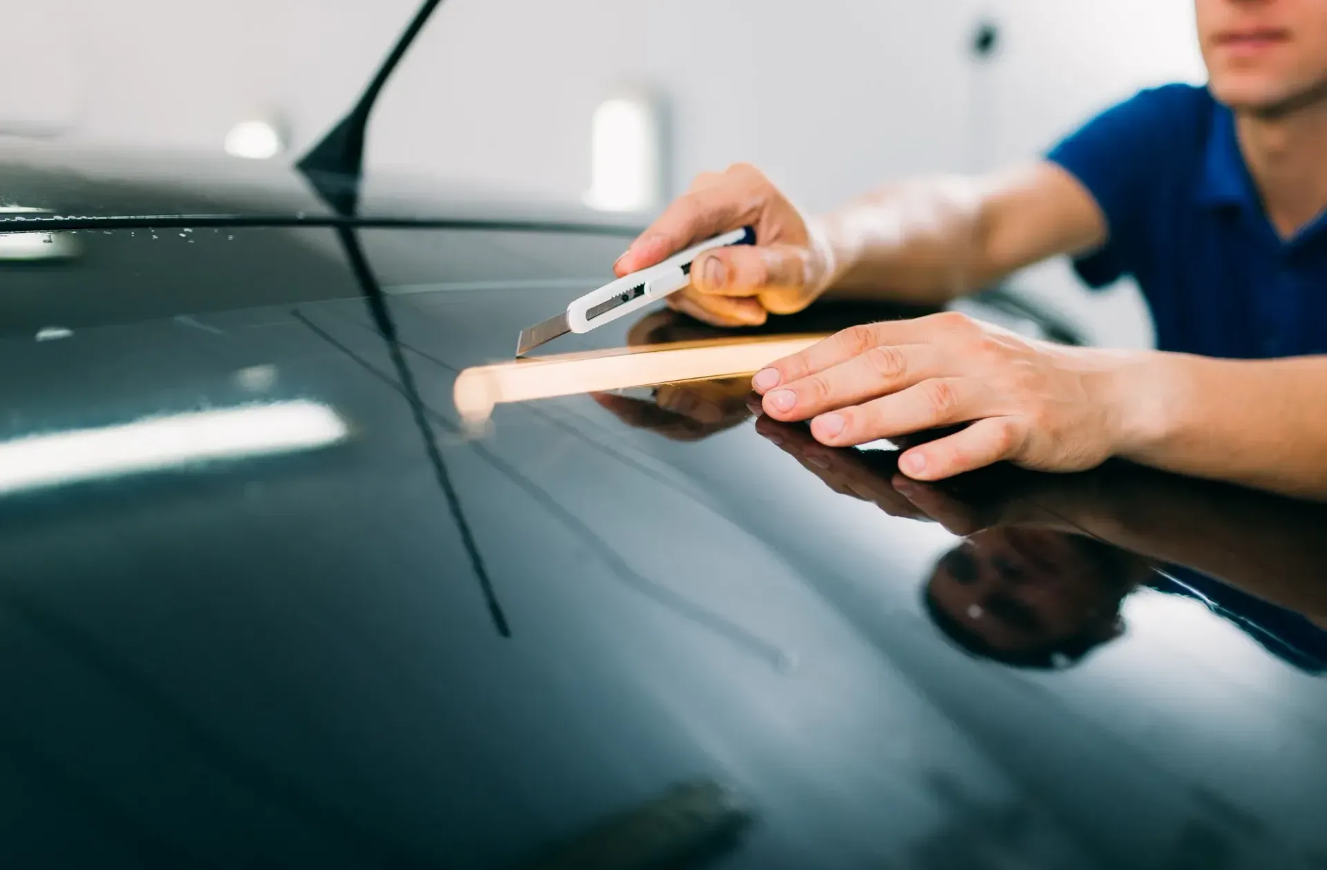 Measuring the rear window to install a ceramic film tint.