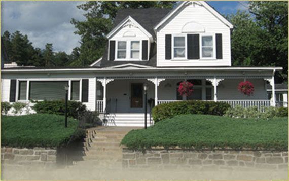 a brick building with a black awning that says funeral home