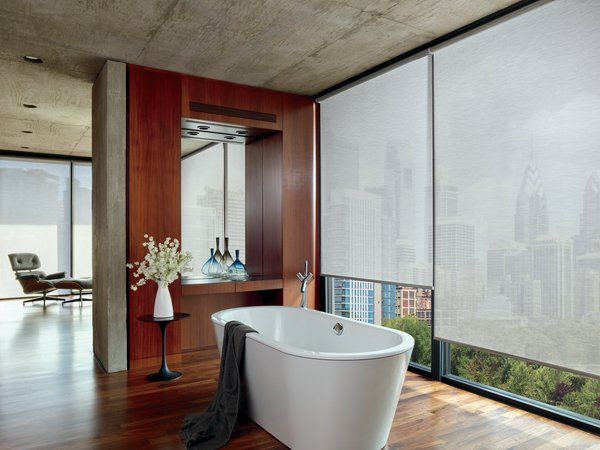 A bathroom with a bathtub and a large window