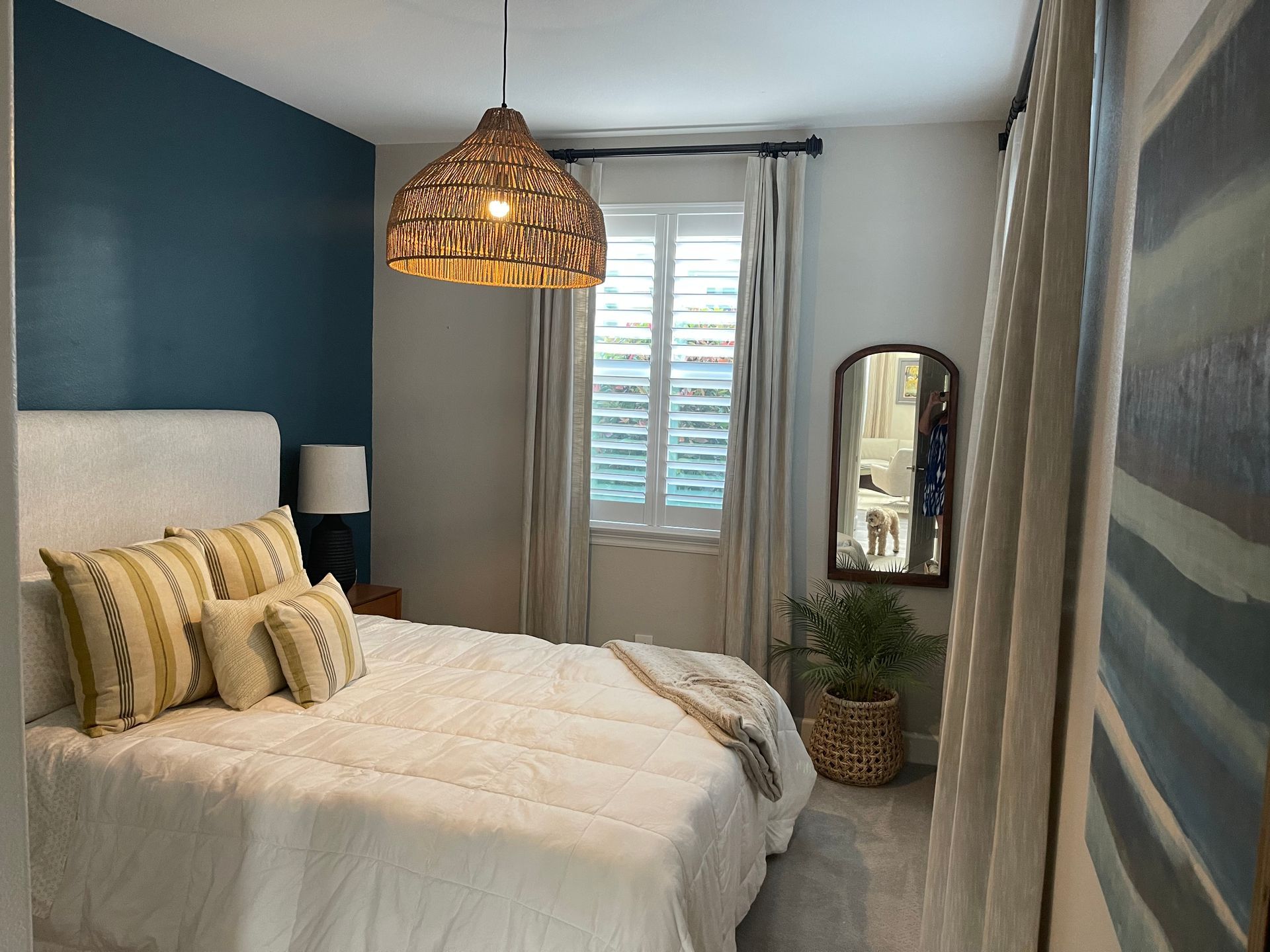 plantation shutters and custom curtains in bedroom windows of Carlsbad, CA home.