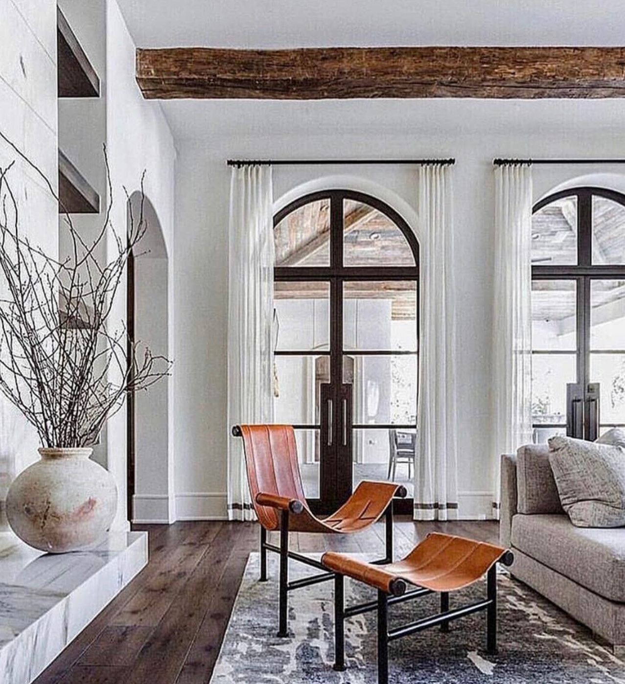 curtains and drapery panels and drapery hardware for the arched windows in living room.