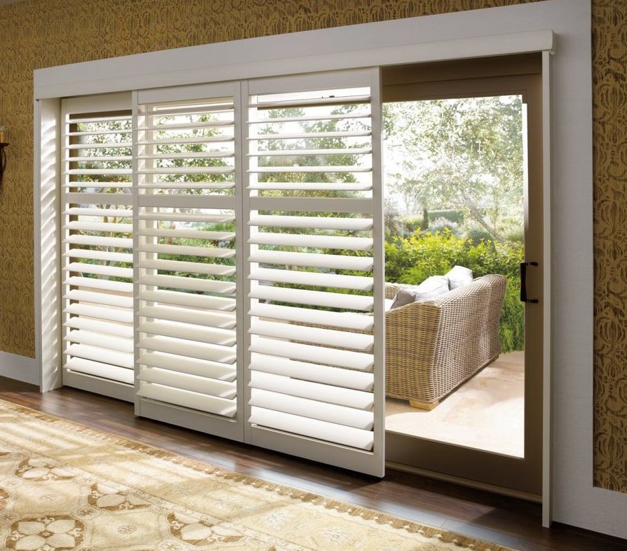 Sliding glass door with white plantation shutters 