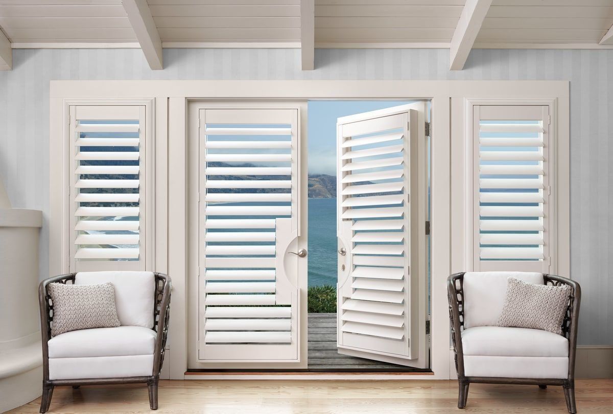 Hunter Douglas Palm Beach™ Shutters on windows and french doors,