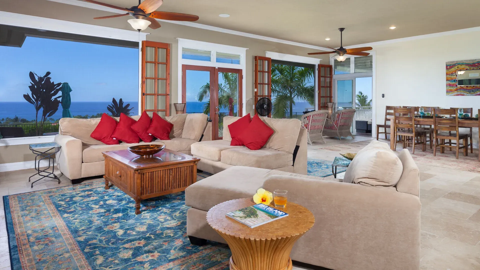 A living room with a lot of furniture and a ceiling fan